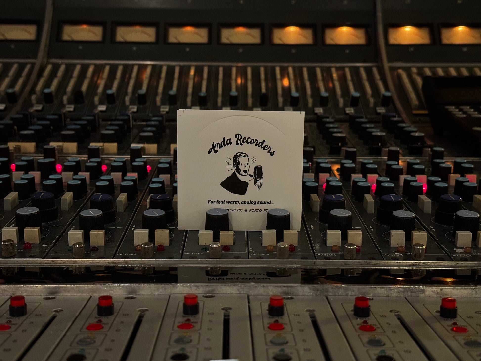 White Arda Recorders logo sticker with black print displayed on analog studio console