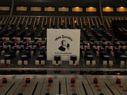 White Arda Recorders logo sticker with black print displayed on analog studio console