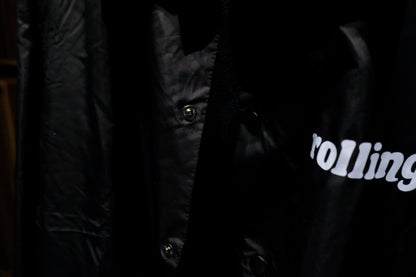 Close-up of a Warm Analog black coach windbreaker jacket for recording studio lifestyle with rolling in the front