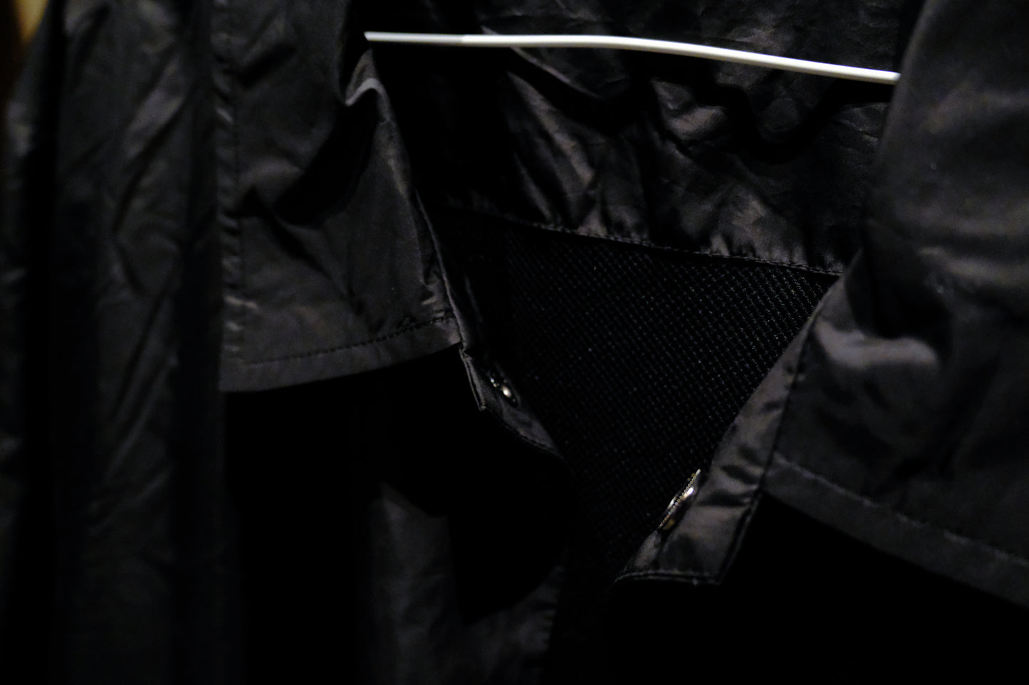 Close-up of a Warm Analog black coach windbreaker jacket for recording studio lifestyle