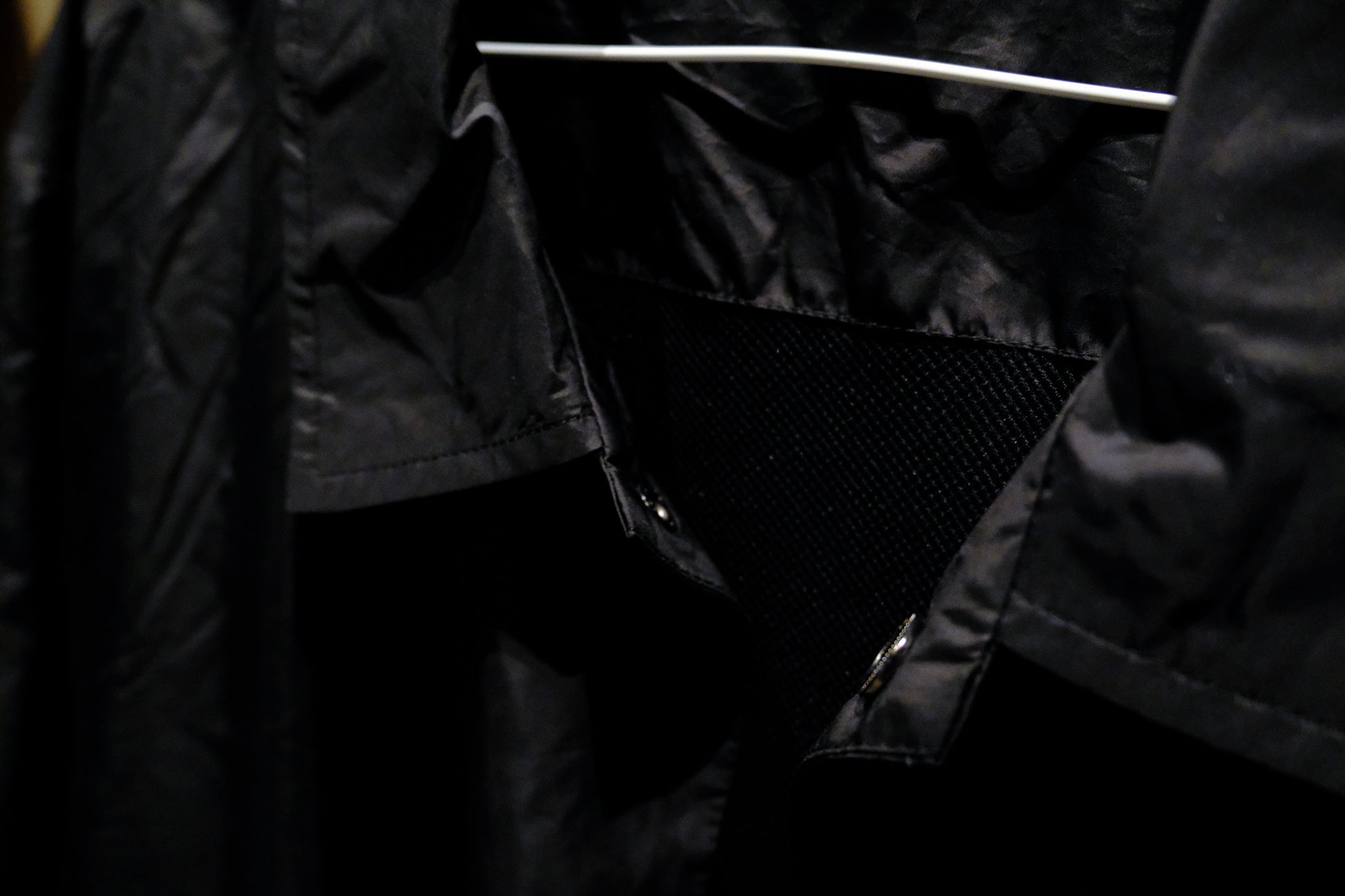 Close-up of a Warm Analog black coach windbreaker jacket for recording studio lifestyle