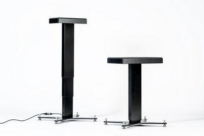 Two Space Lab Systems LIFT active studio monitor stands side-by-side demonstrating the minimum and maximum motorized height extension range